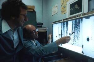 Researcher reading a DNA sequencing gel