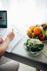 Fresh fruits and vegetables arranged for healthy meal planning in a bright kitchen