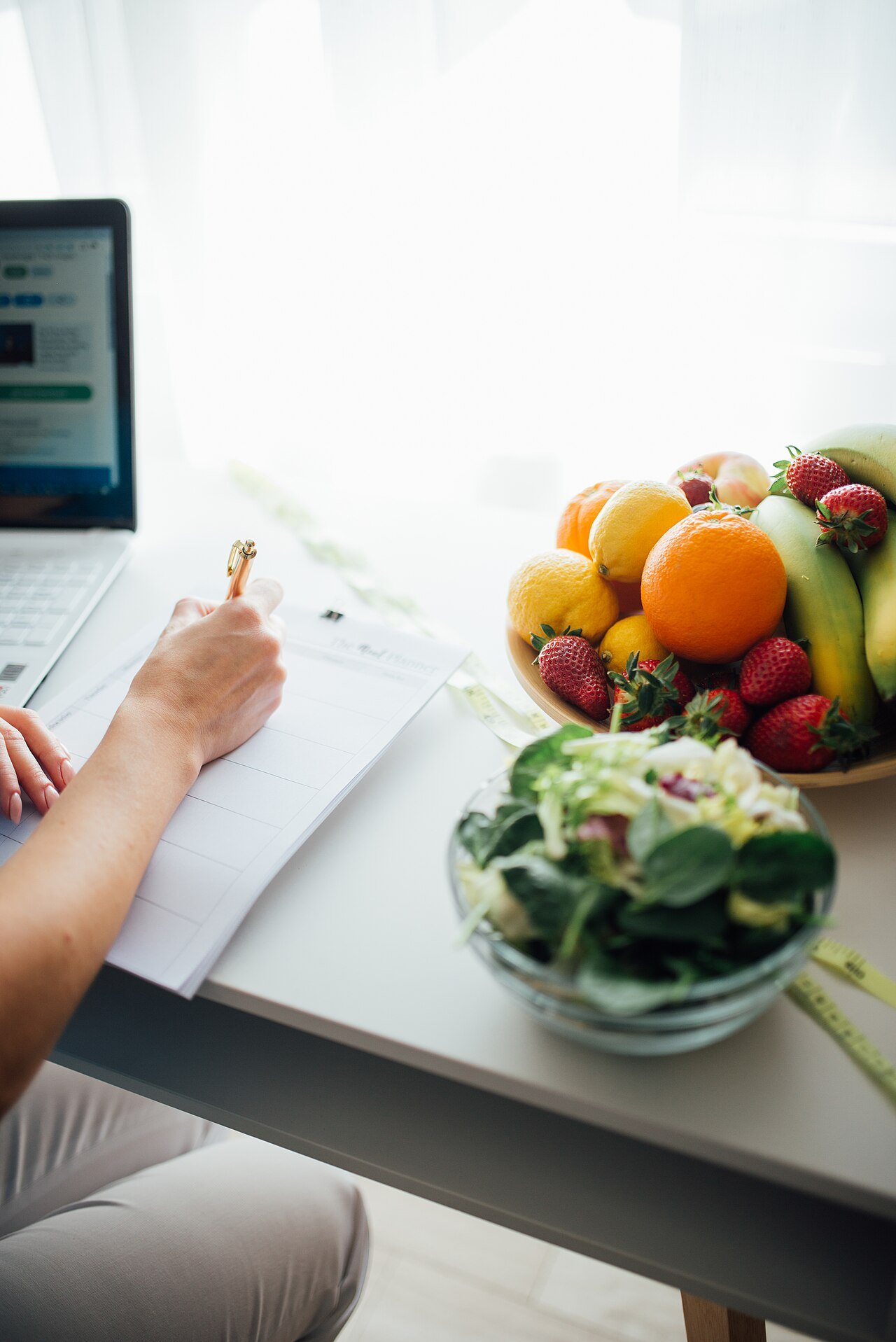 Fresh fruits and vegetables arranged for healthy meal planning in a bright kitchen
