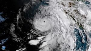 Satellite view of a major hurricane with a well-defined eye just off the Pacific coast of Mexico
