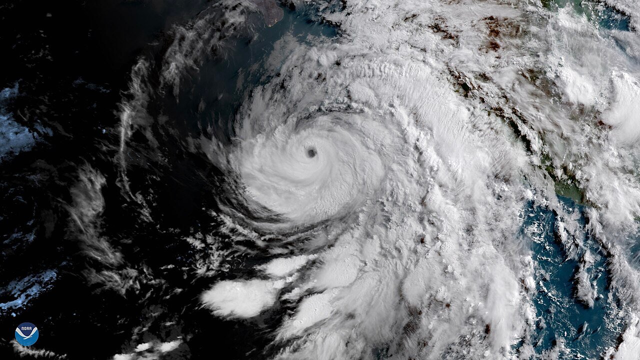 Satellite view of a major hurricane with a well-defined eye just off the Pacific coast of Mexico