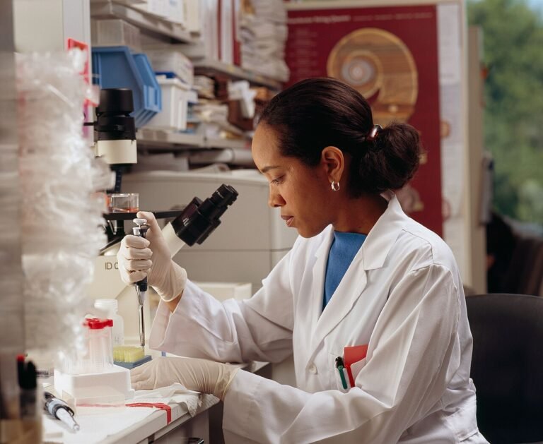 Scientist in a laboratory using a pipette for cancer research