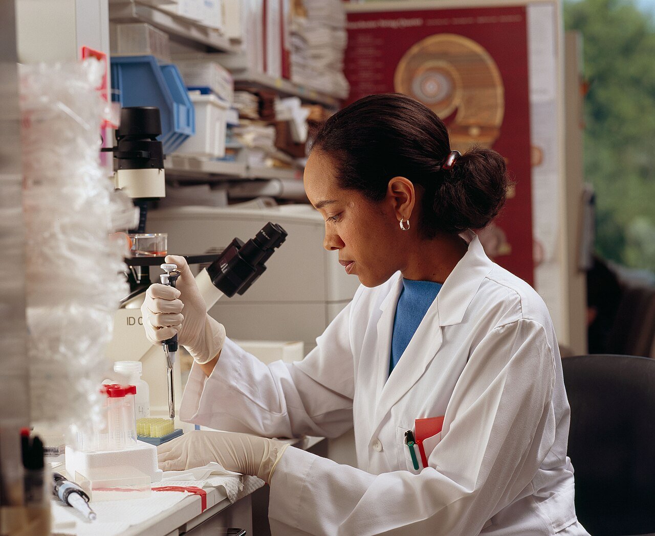 Scientist in a laboratory using a pipette for cancer research