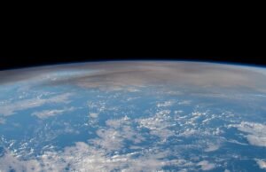 Astronaut photograph of the Hunga Tonga volcanic plume rising over the Pacific Ocean