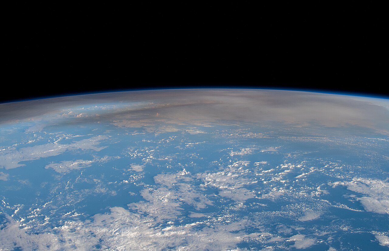 Astronaut photograph of the Hunga Tonga volcanic plume rising over the Pacific Ocean